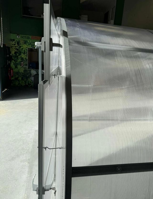 Szklarnia PREMIUM Sigma EVO 3×8 m, poliwęglan 6 mm Otwarte drzwi szklarni PREMIUM Sigma EVO – widok boczny ramy, mocowania i konstrukcji z poliwęglanu